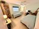 Comfortable bedroom with light walls, featuring two twin beds, and desk at 1727 Waxwing Cir, Venice, FL 34293