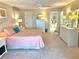 Bright, spacious bedroom featuring light walls, carpeted floors, and a view of an ensuite bathroom at 1727 Waxwing Cir, Venice, FL 34293