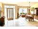 Bright dining room featuring tile floors, traditional furniture, and natural light from a large window at 1727 Waxwing Cir, Venice, FL 34293