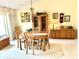 Dining room showcasing carpeted floors, a wooden dining set, chandelier, and built in shelving at 1727 Waxwing Cir, Venice, FL 34293