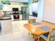 Bright kitchen with stainless steel appliances and tile flooring and adjacent dining area at 1727 Waxwing Cir, Venice, FL 34293