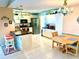Spacious eat-in kitchen with white cabinets, tile floors, black countertops, and stainless steel appliances at 1727 Waxwing Cir, Venice, FL 34293