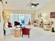 Bright and airy living room with vaulted ceilings and elegant furnishings, offering a view of the pool at 1727 Waxwing Cir, Venice, FL 34293