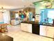 Open concept living space from kitchen, features vaulted ceilings and sliding doors to a sunroom at 1727 Waxwing Cir, Venice, FL 34293
