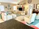 Spacious living room with vaulted ceilings, neutral tones and comfortable seating at 1727 Waxwing Cir, Venice, FL 34293