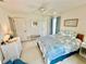 Bright primary bedroom with light flooring and a ceiling fan at 1727 Waxwing Cir, Venice, FL 34293