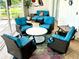 Cozy patio featuring four cushioned swivel chairs and a loveseat with tropical decor, great for relaxing outdoors at 1727 Waxwing Cir, Venice, FL 34293