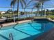 Sparkling pool with screened enclosure and lake views at 1727 Waxwing Cir, Venice, FL 34293