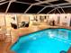 Backyard pool with screened-in patio and multiple seating areas, creating an inviting outdoor entertainment space at 1727 Waxwing Cir, Venice, FL 34293