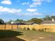 Fenced back yard with a grass lawn and mature landscaping at 3305 Acapulco Dr, Riverview, FL 33578