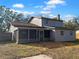 Back of house with screened-in porch and fenced yard, plenty of room for entertaining or relaxation at 3305 Acapulco Dr, Riverview, FL 33578