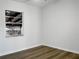 Bedroom with wood look flooring, a window and white painted walls at 3305 Acapulco Dr, Riverview, FL 33578