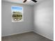 Simple bedroom with neutral carpeting, a bright window, and neutral paint at 3305 Acapulco Dr, Riverview, FL 33578