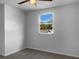 Neutral bedroom features ceiling fan and a window offering natural light and neighborhood views at 3305 Acapulco Dr, Riverview, FL 33578
