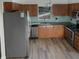 Updated kitchen features stainless steel appliances, granite countertops, and wood cabinets at 3305 Acapulco Dr, Riverview, FL 33578