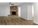 Spacious living room with a stone fireplace, wood-look flooring, and neutral paint at 3305 Acapulco Dr, Riverview, FL 33578