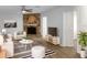 Bright living room featuring modern furnishings, a stone fireplace, and laminate floors at 3305 Acapulco Dr, Riverview, FL 33578