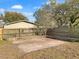 Back yard patio area with stone retaining wall and mature trees at 3305 Acapulco Dr, Riverview, FL 33578