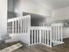 Bright staircase featuring carpeted steps and white banisters leading to a landing with wood-look flooring at 3305 Acapulco Dr, Riverview, FL 33578