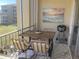 Cozy outdoor dining area on the screened balcony with a grill and a view at 3672 Lake Bayshore Dr # K327, Bradenton, FL 34205