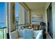 Cozy screened balcony with comfortable seating, beach themed decor, and partial lake view at 3672 Lake Bayshore Dr # K327, Bradenton, FL 34205