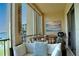 Cozy screened balcony with comfortable seating, beach themed decor, and partial lake view at 3672 Lake Bayshore Dr # K327, Bradenton, FL 34205