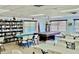 Large community room with game tables and a bookshelf at 3672 Lake Bayshore Dr # K327, Bradenton, FL 34205