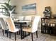 Elegant dining area with seating for six, beach themed art, and a coffee bar setup at 3672 Lake Bayshore Dr # K327, Bradenton, FL 34205