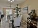 Bright dining room featuring modern table set, stylish decor, and beach-themed artwork at 3672 Lake Bayshore Dr # K327, Bradenton, FL 34205