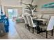 Bright living room and dining area with beach themed artwork, tile floors, and neutral tones at 3672 Lake Bayshore Dr # K327, Bradenton, FL 34205