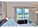 Serene main bedroom features sliding glass doors with a view of the lake at 3672 Lake Bayshore Dr # K327, Bradenton, FL 34205