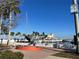 Picturesque marina view with sailboats, yachts, and lush tropical landscaping against a blue sky at 3672 Lake Bayshore Dr # K327, Bradenton, FL 34205