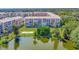 Beautiful lakefront condo complex with lush landscaping and serene water views at 3672 Lake Bayshore Dr # K327, Bradenton, FL 34205