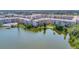 Gorgeous community aerial view of lakefront condo buildings with sparkling lake water and beautifully manicured landscapes at 3672 Lake Bayshore Dr # K327, Bradenton, FL 34205