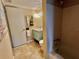 Functional bathroom with a blue vanity and standard bathtub and shower combo at 3672 Lake Bayshore Dr # K327, Bradenton, FL 34205
