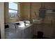 Community laundry room with multiple washing machines and a window providing natural light at 3672 Lake Bayshore Dr # K327, Bradenton, FL 34205