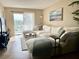 Bright living area with a plush white sectional sofa and a serene view of the waterfront at 3672 Lake Bayshore Dr # K327, Bradenton, FL 34205