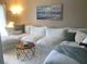 Bright and airy living room with a soft white sectional, accent pillows, and a chic coffee table at 3672 Lake Bayshore Dr # K327, Bradenton, FL 34205