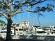 Marina filled with docked boats, framed by a tree and a low white wall at 3672 Lake Bayshore Dr # K327, Bradenton, FL 34205