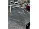 Designated parking spot for unit 323 with a yellow painted number on the asphalt parking lot at 3672 Lake Bayshore Dr # K327, Bradenton, FL 34205