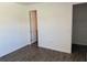 This bedroom features wood-style tile floors, neutral walls, and a closet or ensuite bathroom at 25164 Calusa Dr, Punta Gorda, FL 33955