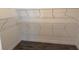 Walk-in closet with wire shelving and dark flooring, providing ample storage space at 25164 Calusa Dr, Punta Gorda, FL 33955