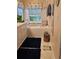 Bright bathroom features a soaking tub, double sink vanity and a large window at 424 N Carolina Ave, Palm Harbor, FL 34683