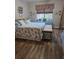 Cozy bedroom featuring wood floors, a large window and a beach-themed decor at 424 N Carolina Ave, Palm Harbor, FL 34683