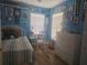 Blue bedroom with a single bed, white dresser and walls decorated with pictures at 424 N Carolina Ave, Palm Harbor, FL 34683