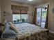 Bedroom featuring wood floors and a sliding glass door leading to the outdoor patio at 424 N Carolina Ave, Palm Harbor, FL 34683