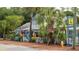 Charming business exterior featuring palm trees, an American flag, and an inviting storefront at 424 N Carolina Ave, Palm Harbor, FL 34683