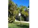 Well-maintained home with lush landscaping, including a palm tree and vibrant green lawn at 424 N Carolina Ave, Palm Harbor, FL 34683