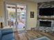 Spacious living area featuring a cozy fireplace and seamless access to a screened lanai at 424 N Carolina Ave, Palm Harbor, FL 34683