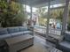 Relaxing screened patio with sectional seating overlooking backyard at 424 N Carolina Ave, Palm Harbor, FL 34683